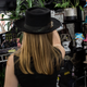 A customer tries on a hat at the Crystal Birch shop.